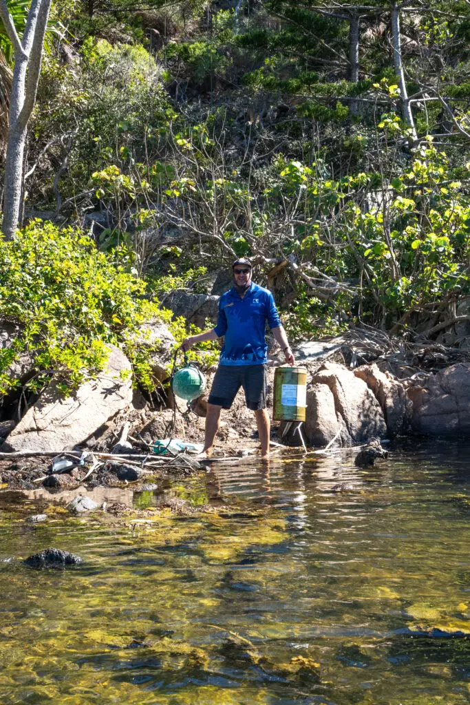 Ocean Rafting Staff carrying rubbish off beach